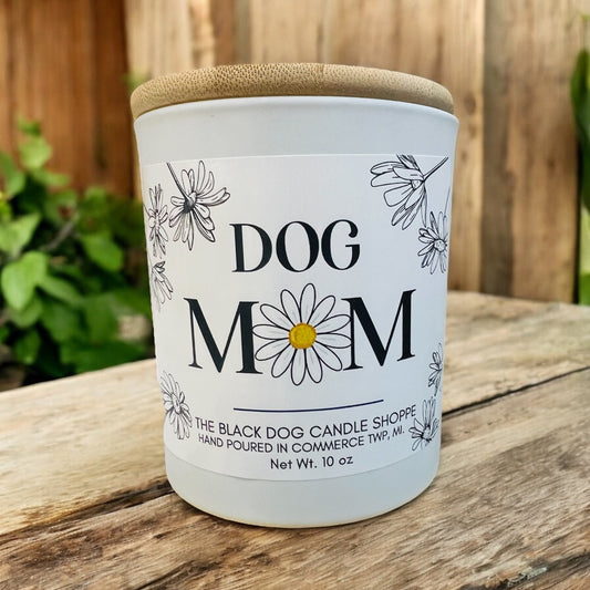white candle with dog mom text and flower graphics