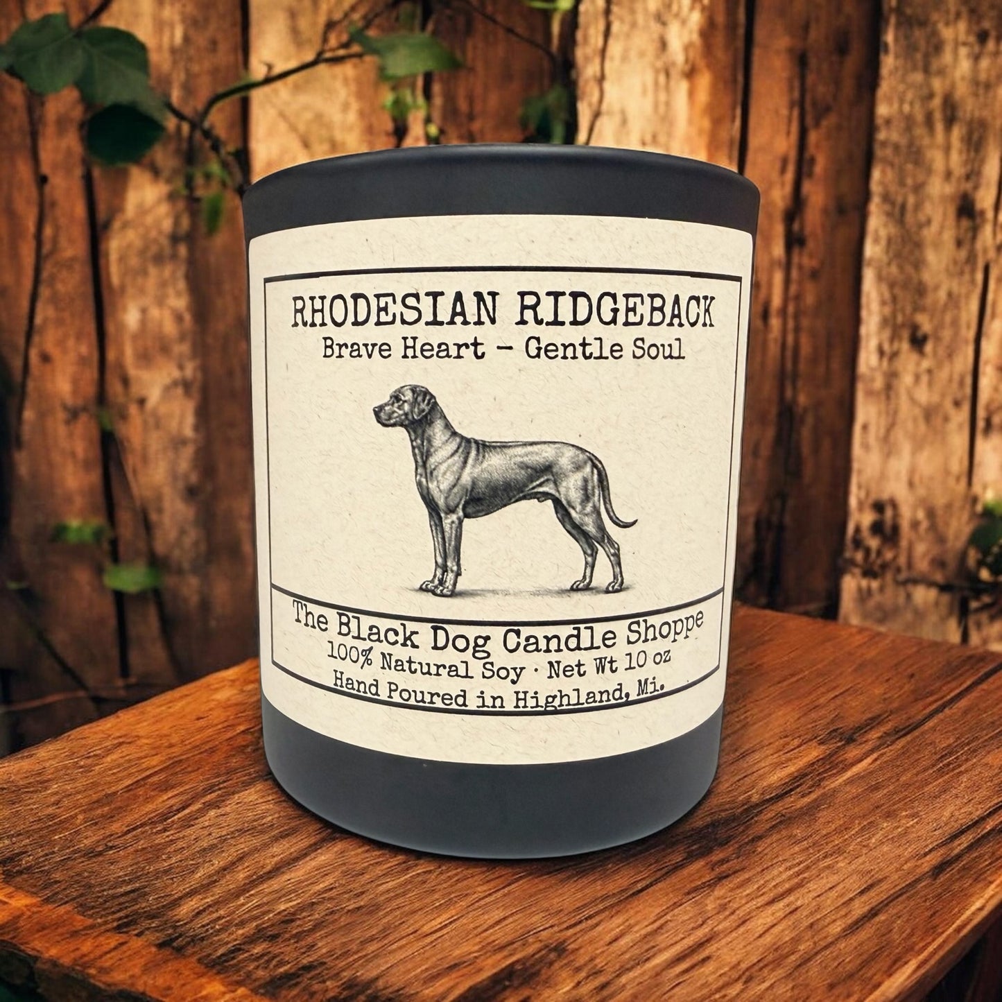 Rhodesian Ridgeback soy candle in matte black jar with bamboo lid, featuring vintage dog illustration and “Brave Heart – Gentle Soul” label on rustic wood background