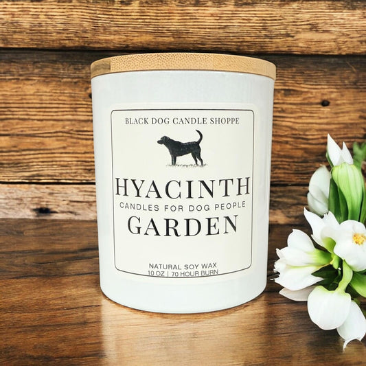 Hyacinth Garden soy candle in white glass jar with bamboo lid, featuring minimalist label design, styled with white flowers on rustic wood background