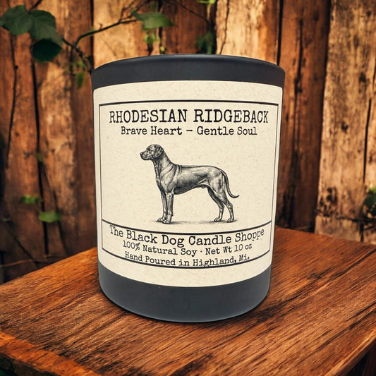 Rhodesian Ridgeback soy candle in matte black jar with bamboo lid, featuring vintage dog illustration and “Brave Heart – Gentle Soul” label on rustic wood background